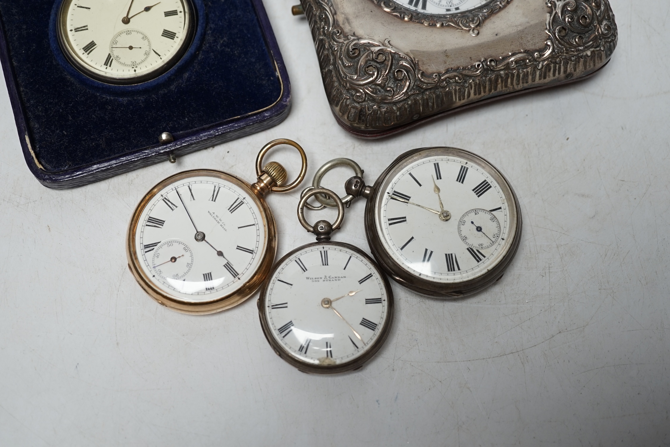 A George V repousse silver mounted travelling watch case (a.f.), with pocket watch, three silver open face pocket watches and a Waltham gold plated pocket watch. Condition - poor to fair